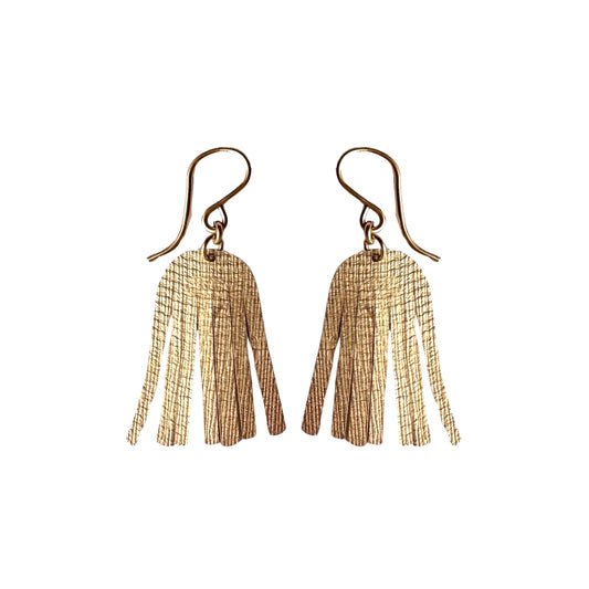 gold shimmering dangle earrings on white background