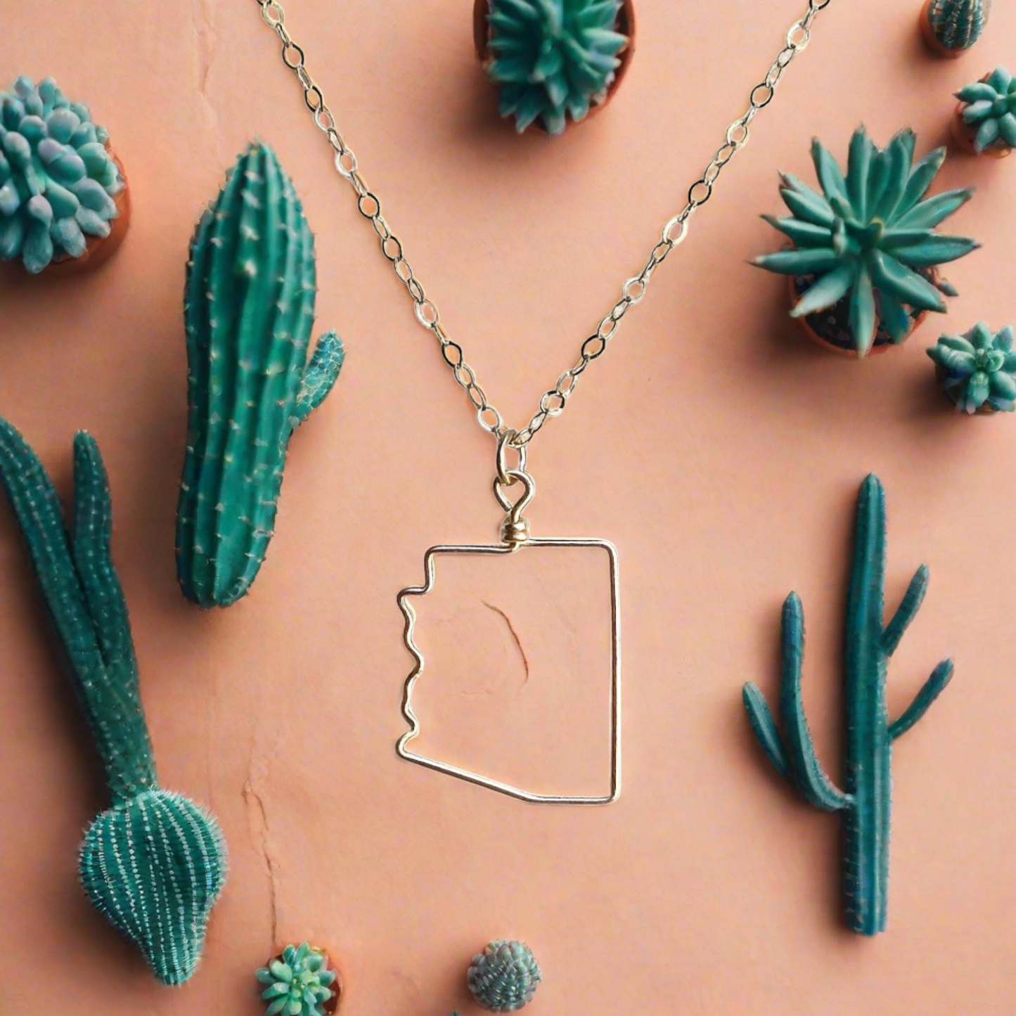 gold arizona necklace with cactus background