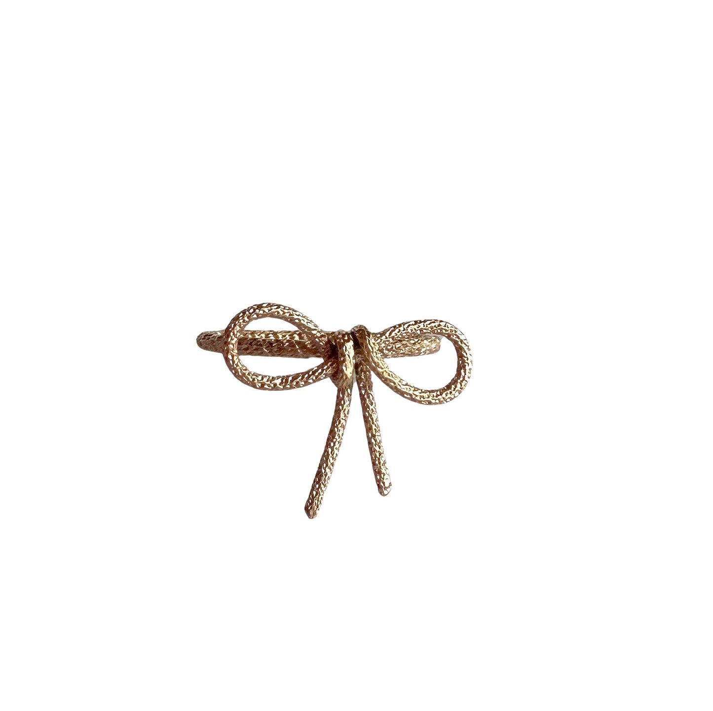 Gold bow ring made from textured wire formed into the shape of a ribbon or bow with 2 loops and 2 dangling ribbons 