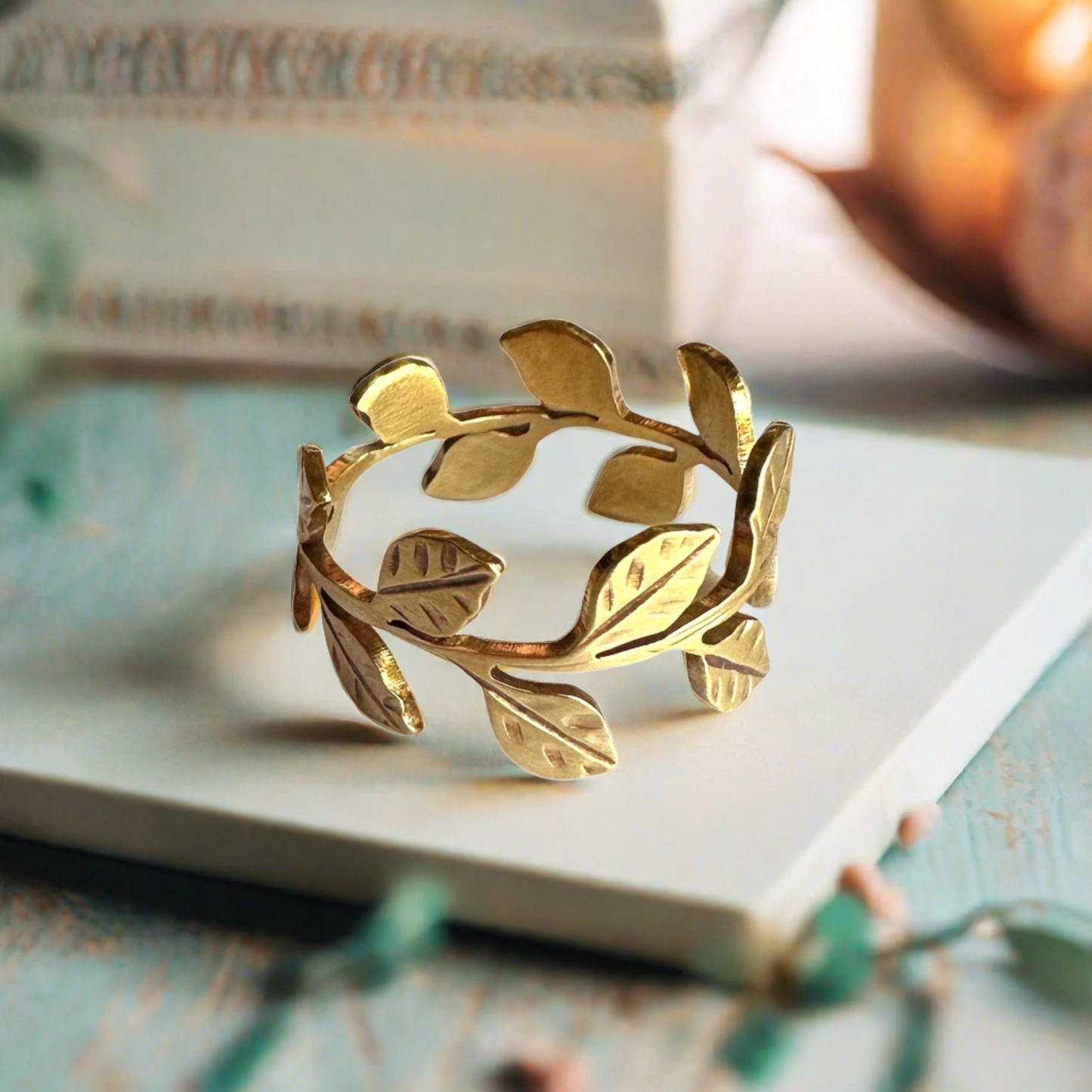 gold vine leaf ring with warm bright setting