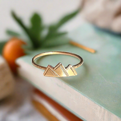 gold ring featuring mountains that have been saw cut from sheet metal and soldered onto a dainty band