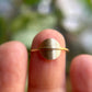 gold circle ring on finger