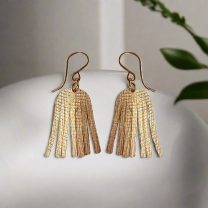 gold shimmery earrings on AI generated background