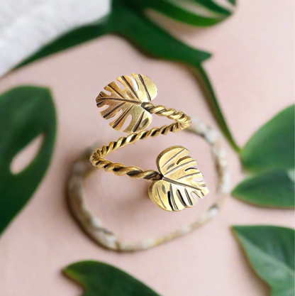 gold monstera leaf ring with 2 leaves with tropical background