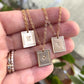 custom zodiac sign necklaces in gold filled draped across a hand